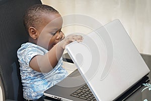 Preschooler e-learning online at home with a laptop