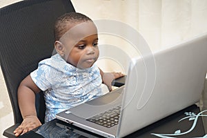 Preschooler e-learning online at home with a laptop