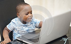 Preschooler e-learning online at home with a laptop