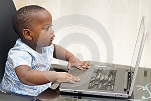 Preschooler e-learning online at home with a laptop