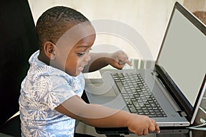 Preschooler e-learning online at home with a laptop