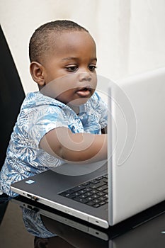 Preschooler e-learning online at home with a laptop