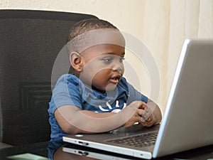 Preschooler e-learning online at home with a laptop