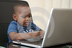 Preschooler e-learning online at home with a laptop