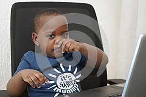 Preschooler e-learning online at home with a laptop