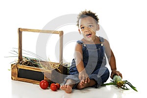 Preschooler with Garden Veggies