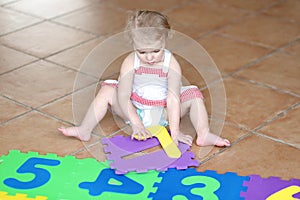 Preschooler girl playing with puzzles learning numbers