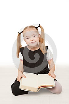 Preschooler girl reading a book.