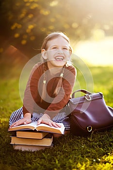 Preschooler girl ready back to school, reading textbooks