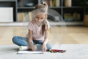 Preschooler little girl drawing in living room