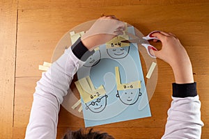 preschooler mathematics activity, kids hands cut paper with numbers