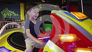 Preschooler playing on amusement park and slot machines