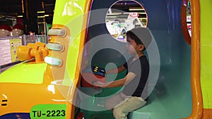 Preschooler playing on amusement park and slot machines