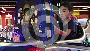 Preschooler playing on amusement park and slot machines