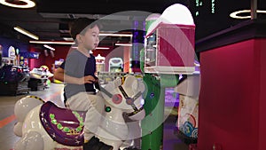 Preschooler playing on amusement park and slot machines