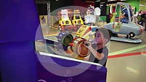 Preschooler playing on amusement park and slot machines