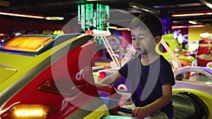 Preschooler playing on amusement park and slot machines