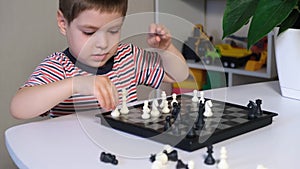 A preschooler plays chess, makes castling