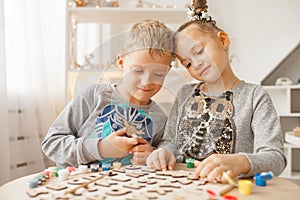 Preschoolers play and learn English letters using wooden alphabet.