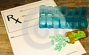 Prescription bottle with green pills, pill minder on RX form