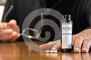 Prescription bottle with Oxycodone tablets on a table