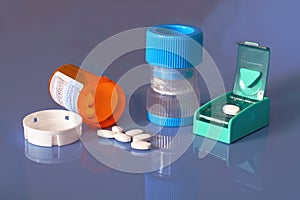 Prescription bottle, pills, pill crusher, splitter photo