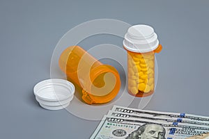 Prescription drugs and medication bottles with cash money.