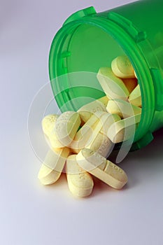Prescription naproxen tablets spilling onto grey table