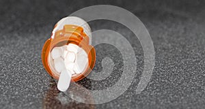 Prescription pill bottlelying on black counter with white pills