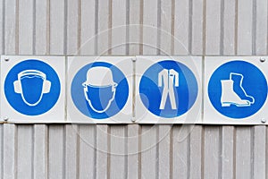 Prescriptive safety signs and posters of personal protective equipment at work.