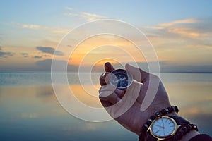 The presence of a lake. Compass with a watch in harmony with nature. Kazakhstan. Lake Balkhash