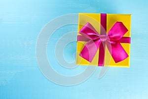 Present box on blue background greeting card holidays concept