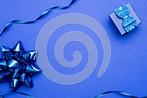 Present box on blue background greeting card holidays concept