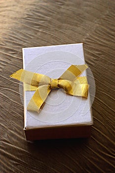 Present box with gold ribbon