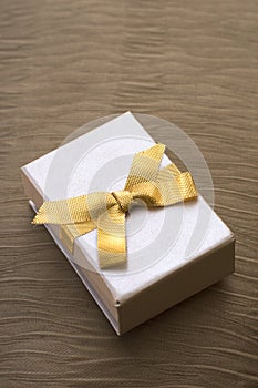Present box with gold ribbon