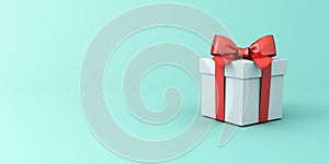 Present box with red ribbon and bow or white gift box on light blue green pastel color with blank space gradient