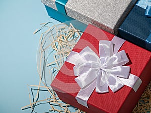 Present boxes on blue background greeting card holidays concept.