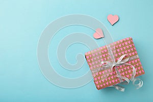 Present boxes with pink heart on blue background greeting card holidays concept. Happy Mother`s day