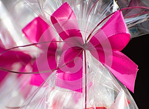 Present in a cellophane foil with a pink bow