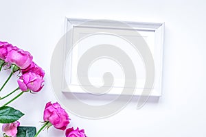 Present design with peony bouquet and white frame top view mock up