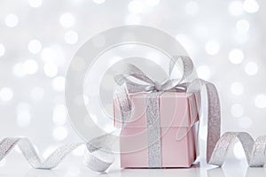 Present or gift box against bokeh background. Holiday greeting card on Birthday or Christmas.