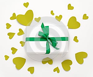 Present gift box flat lay. Top view valentines day decorations. Gift box, green ribbon, hearts. Birthday banner template