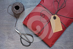 Present in red pack with tag and retro scissors