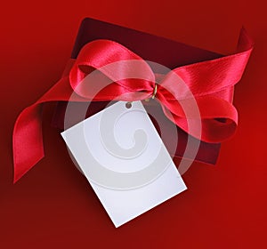 Present with red ribbon and card.