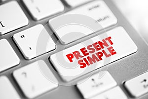 Present Simple - one of the verb forms associated with the present tense in modern english, text concept button on keyboard