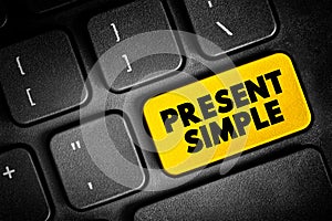 Present Simple - one of the verb forms associated with the present tense in modern english, text concept button on keyboard