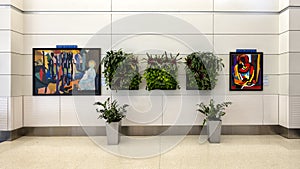 Presentation of reproductions of paintings and plants in Detroit Airport by the Detroit Institue of Arts.