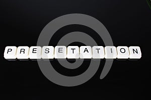 Presentation text word title caption label cover backdrop background. Alphabet letter toy blocks on black reflective background. W