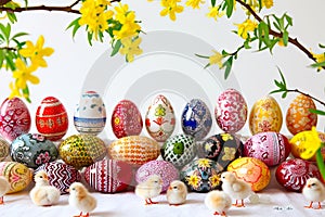 Presentation of variously hand-painted Easter eggs on a white background.