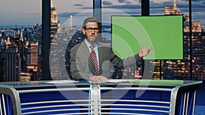 Presenter showing green screen reporting breaking news in tv channel studio.